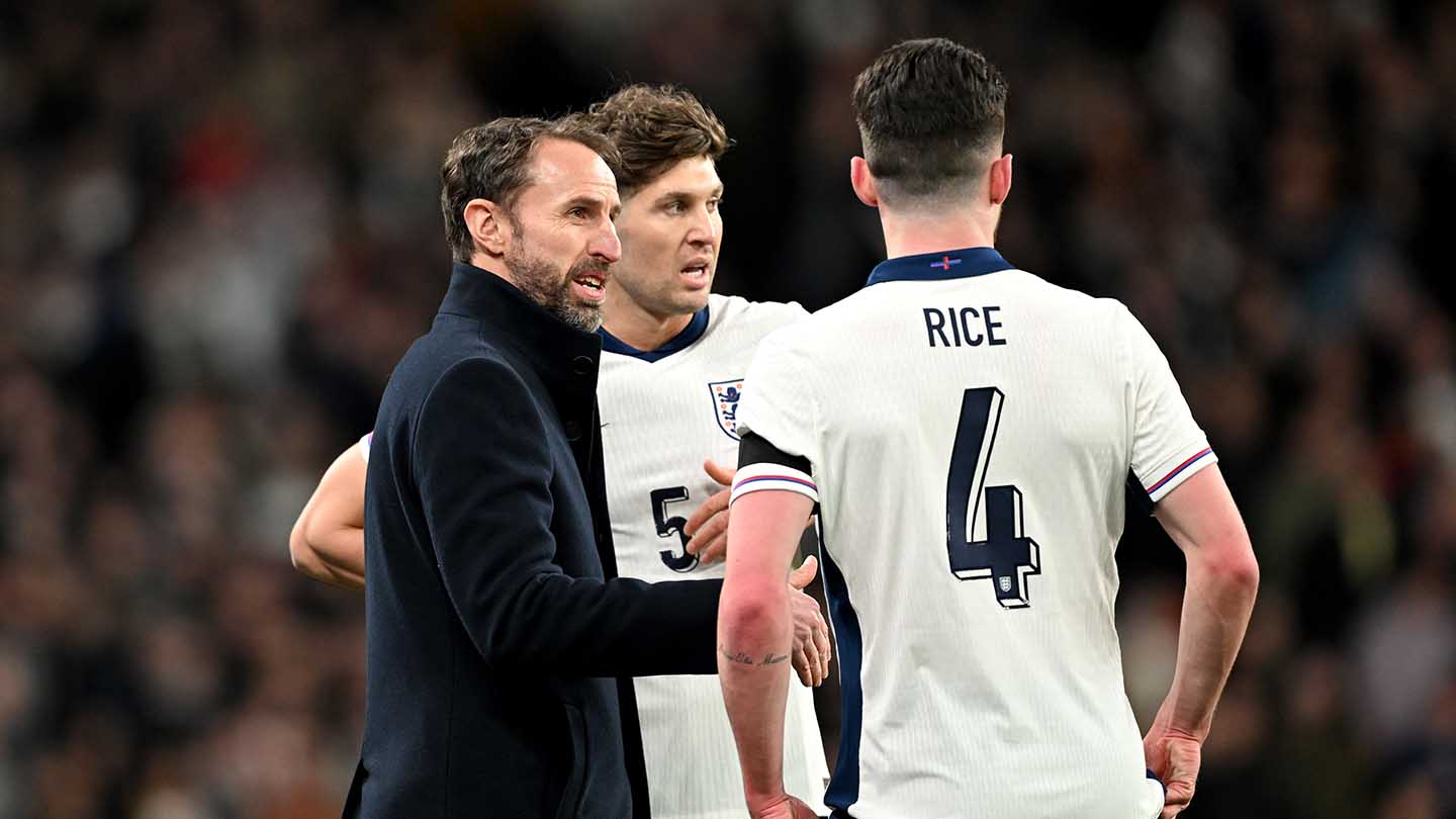 England manager Gareth Southgate talks to his players in the game with Brazil